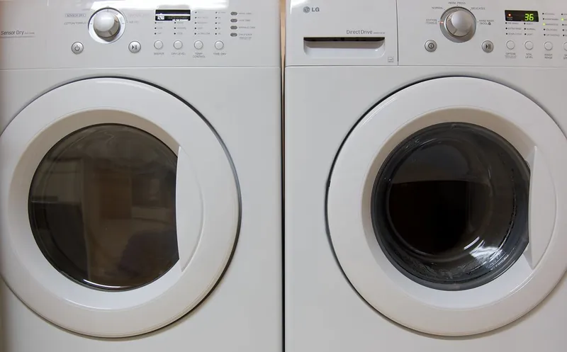 White front-load dryer next to a matching washer