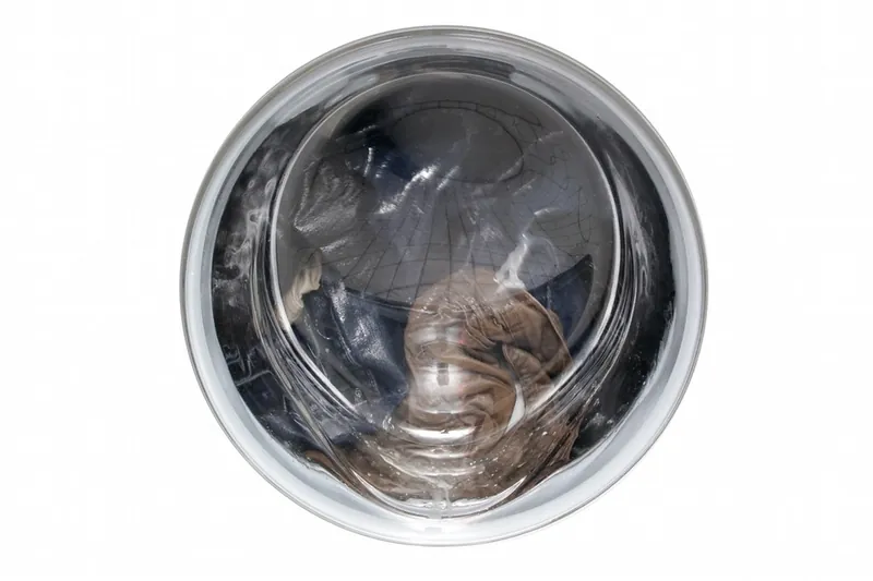 Front-load washing machine door glass with laundry inside